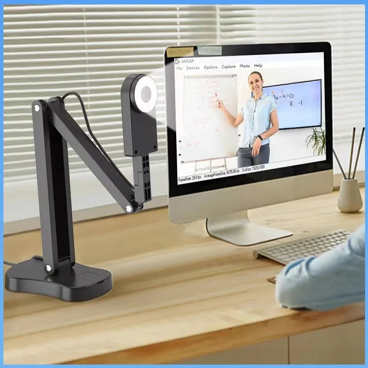 USB computer webcam with a built-in microphone on a desk, showing different model options with remote controls and cables.
