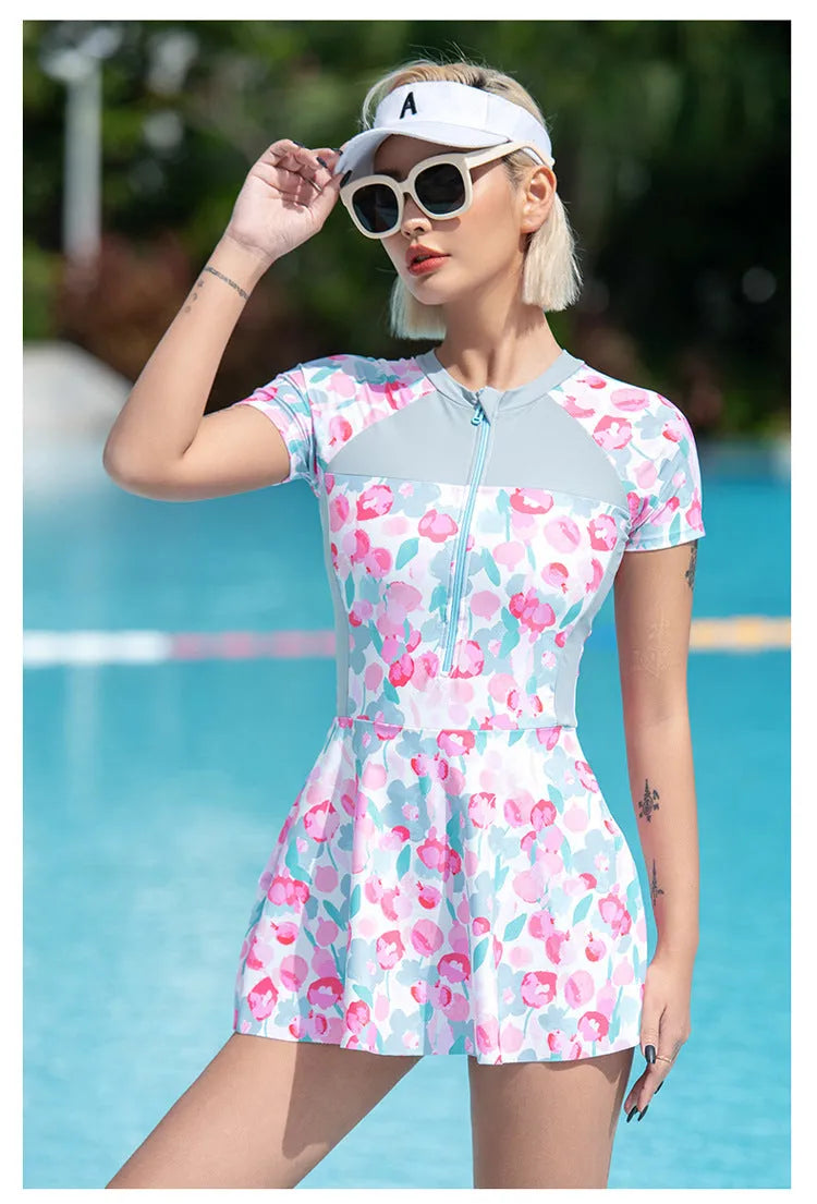 Women's printed plus size one-piece swimsuit on hanger, available in sizes M to 3XL.