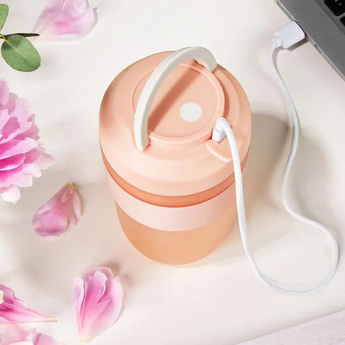 Portable purple rechargeable blender cup with four stainless steel blades, 400ml capacity, shown with USB cable.