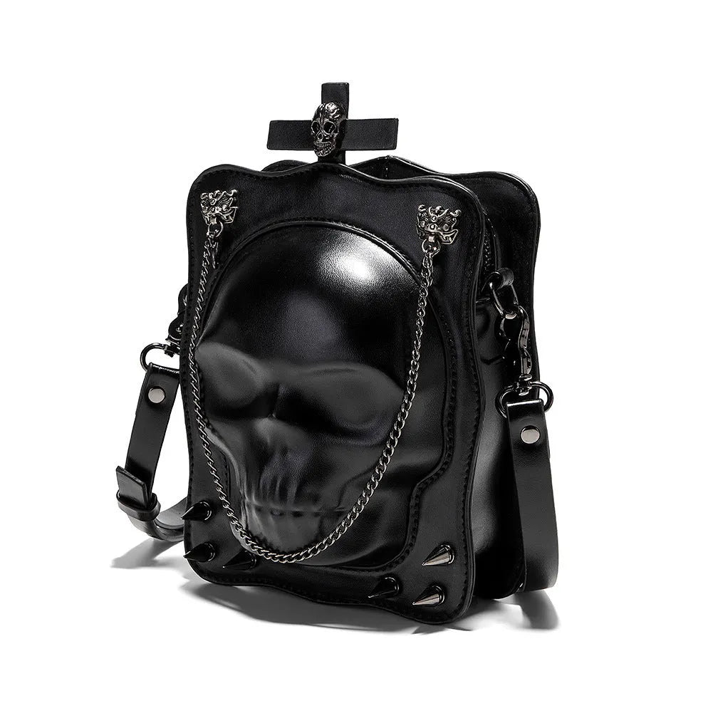 Black mini square messenger bag with a gothic embossed skull design, chain detail, and a crossbody strap.