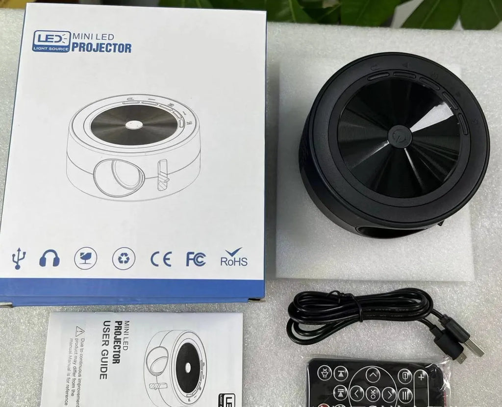 YT200 portable LED projector in black, white, yellow and white, or blue and white colours with remote control