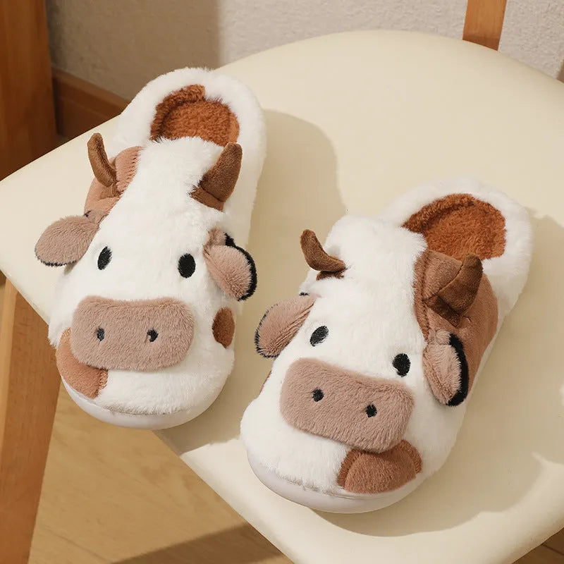 White cow print faux fur slippers for women with a non-slip textured sole.