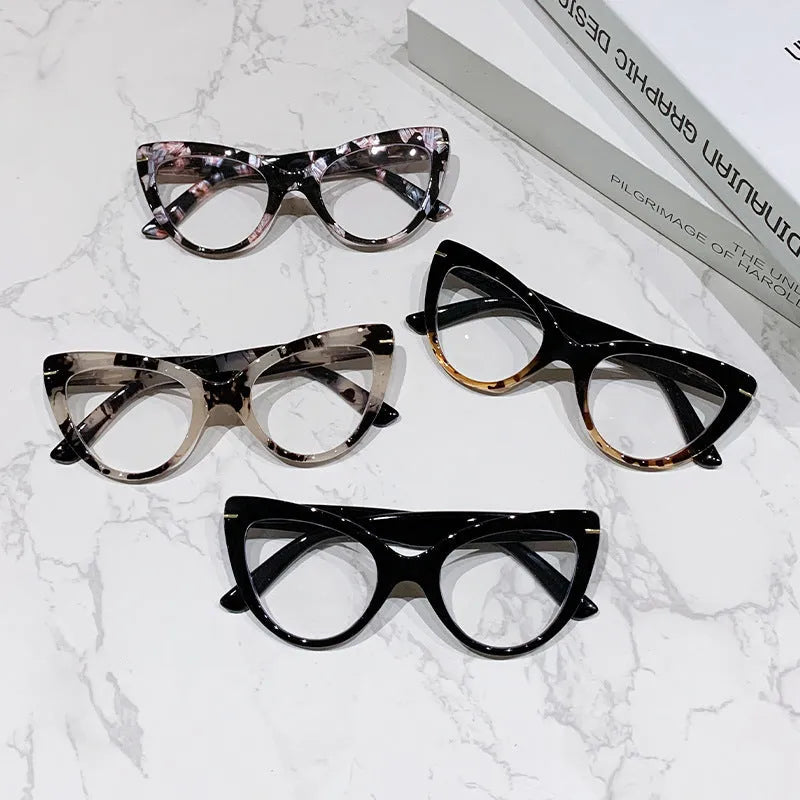Women's large cat's eye frame glasses with dragon and phoenix decorations, shown in various colour options.