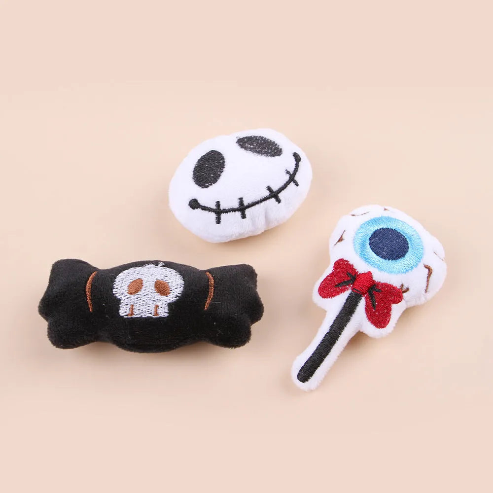 Small plush cat teaser toy with candy, eyes or skull design and feather attachment