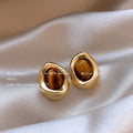 Women's geometric holiday earrings in alloy with electroplated finish and tassel elements