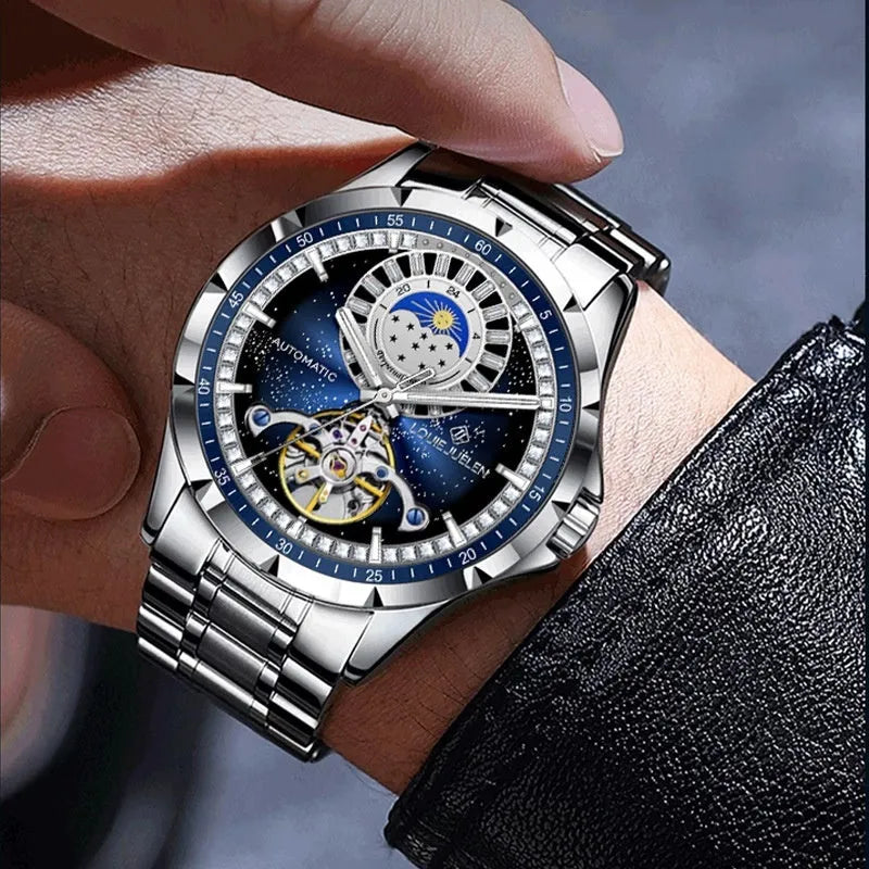 Men's silver alloy automatic watch with blue dial and stainless steel bracelet on wrist.