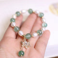 Green handmade freshwater pearl bracelet with strawberry pearls and Chinese knot design
