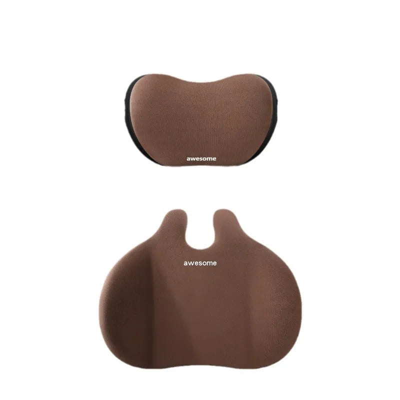 Cow head style black car headrest pillow and matching lumbar support pillow set on a car seat.