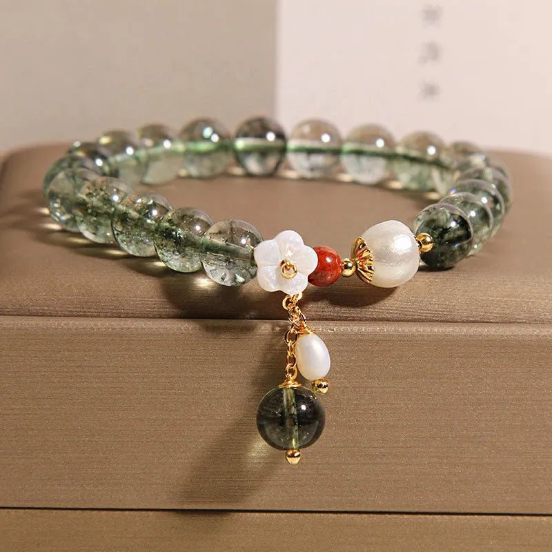 Green phantom quartz crystal bracelet with shell flower and Bells of Ireland design