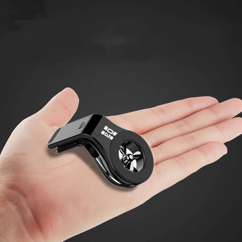 Black magnetic car air vent phone holder with adjustable ball joint and fragrance disc attached.