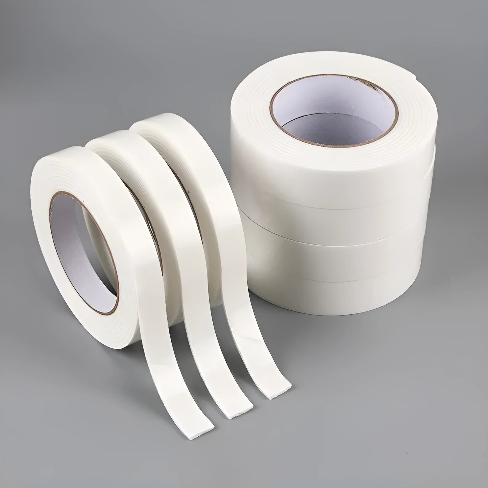 Roll of 3mm thick white foam double-sided adhesive tape showing its spongy core and strong adhesive on both sides.