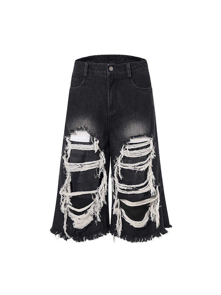 Black women's cropped wide-leg jeans with ripped patch detail and a mid-high waist