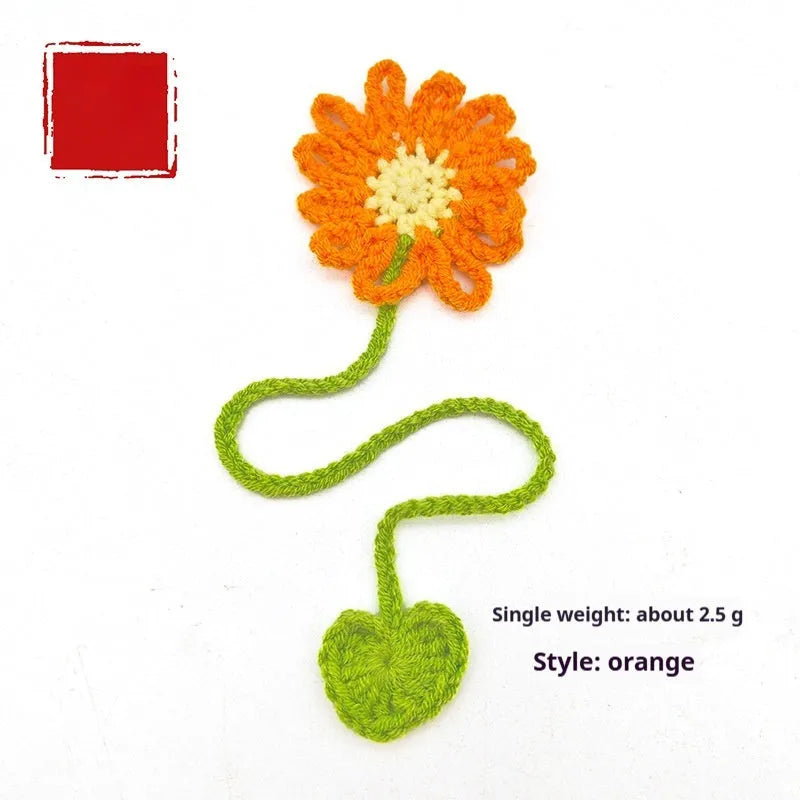 Hand-crocheted wool bookmark with small daisy motifs in multiple colour options
