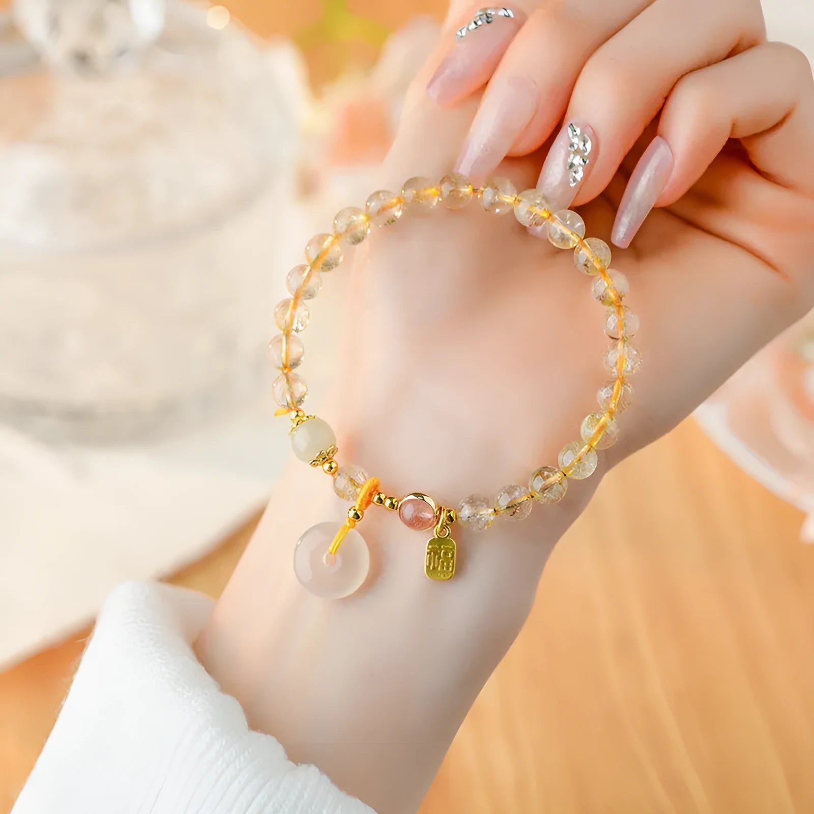 Gold rutilated quartz crystal bracelet with safety buckle closure and geometric pendant