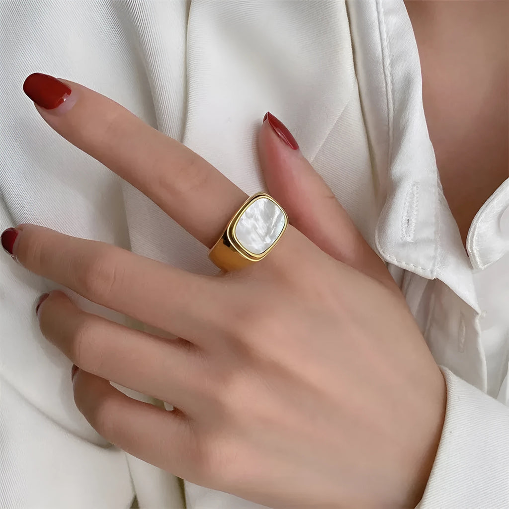 Silver white fashion ring with glossy finish and simulated diamond centre stone on light background