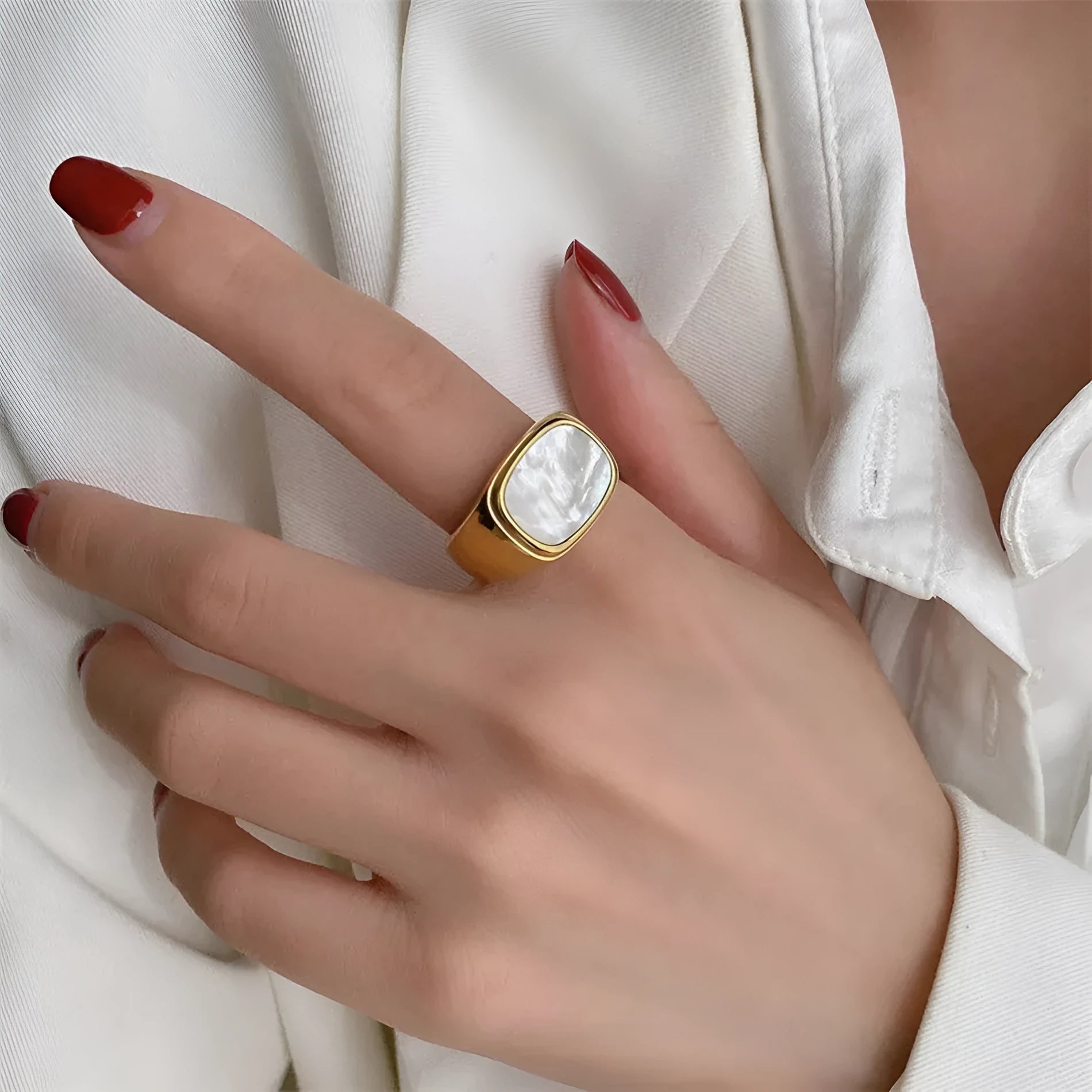 Silver white fashion ring with glossy finish and simulated diamond centre stone on light background