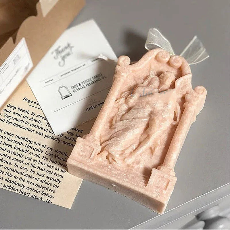 Food-grade silicone mould showing detailed Ancient Greek couple angel design for baking and crafts.