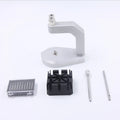 Silver tool steel press strap removal tool for watch bands and jewellery on a grey background.