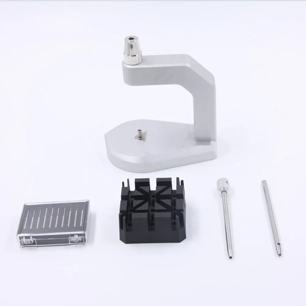 Silver tool steel press strap removal tool for watch bands and jewellery on a grey background.