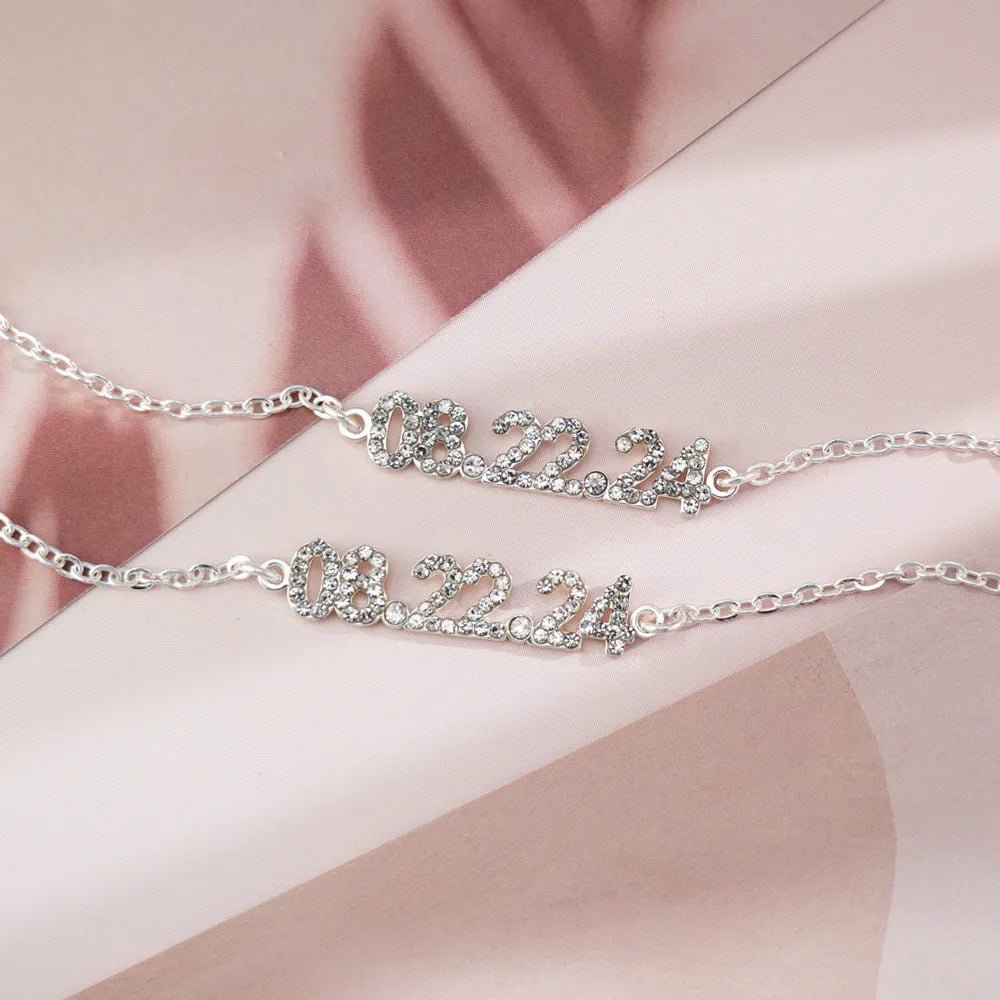 Stainless steel digital bracelet with diamond-set number display on wrist.