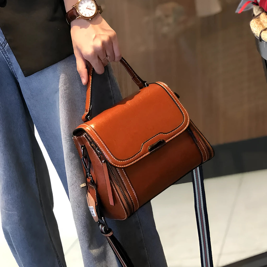 Women's brown genuine leather messenger bag with shoulder strap and internal pockets