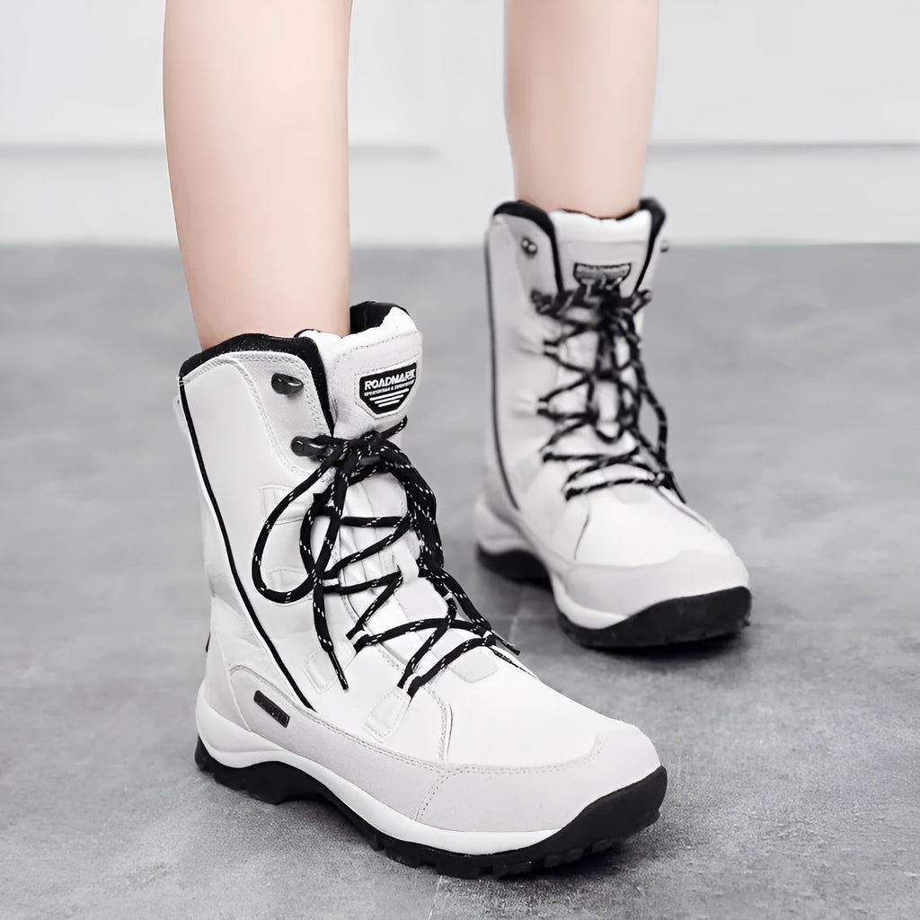 Women's white genuine leather mid-calf snow boots with a round toe and rubber sole on a plain background.