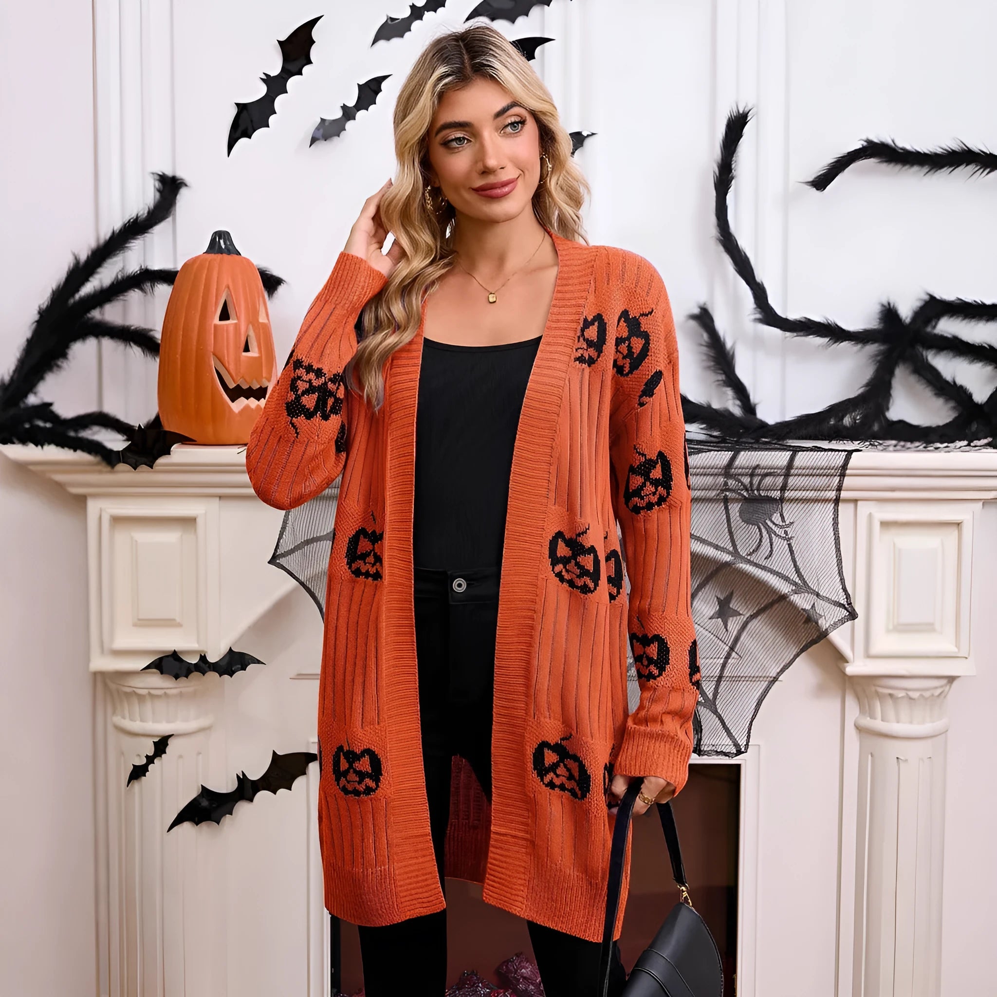 Women's black Halloween cardigan with orange pumpkin head jacquard knitting.