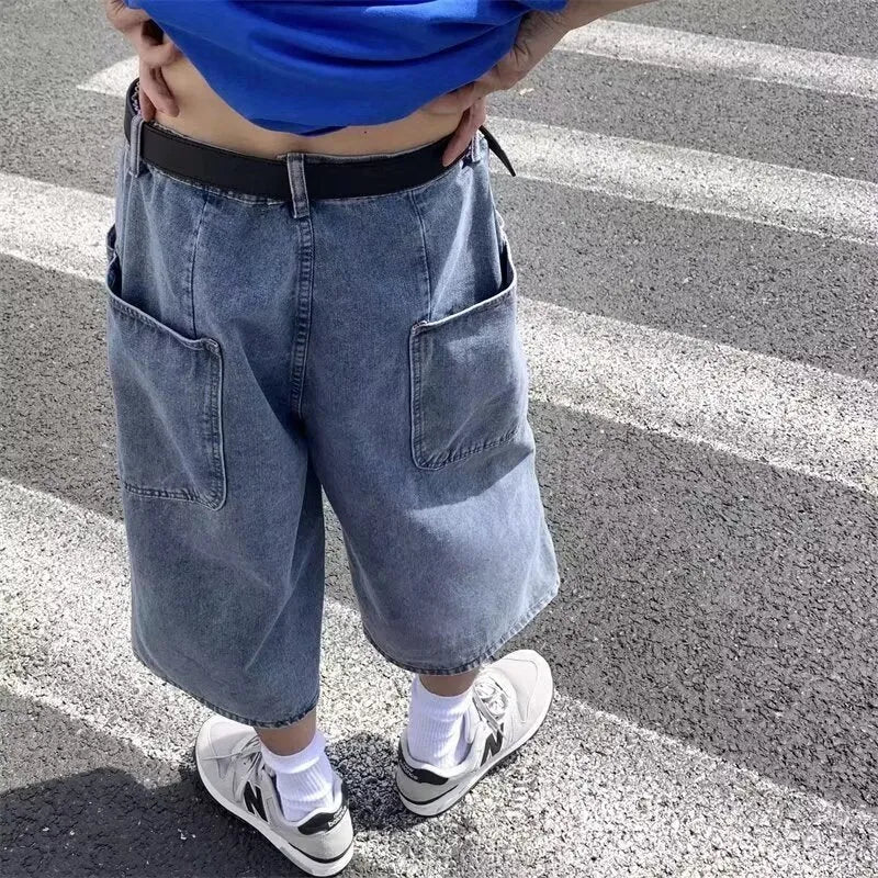 Blue men's high-waist denim pirate shorts with a cropped length and zipper fly.