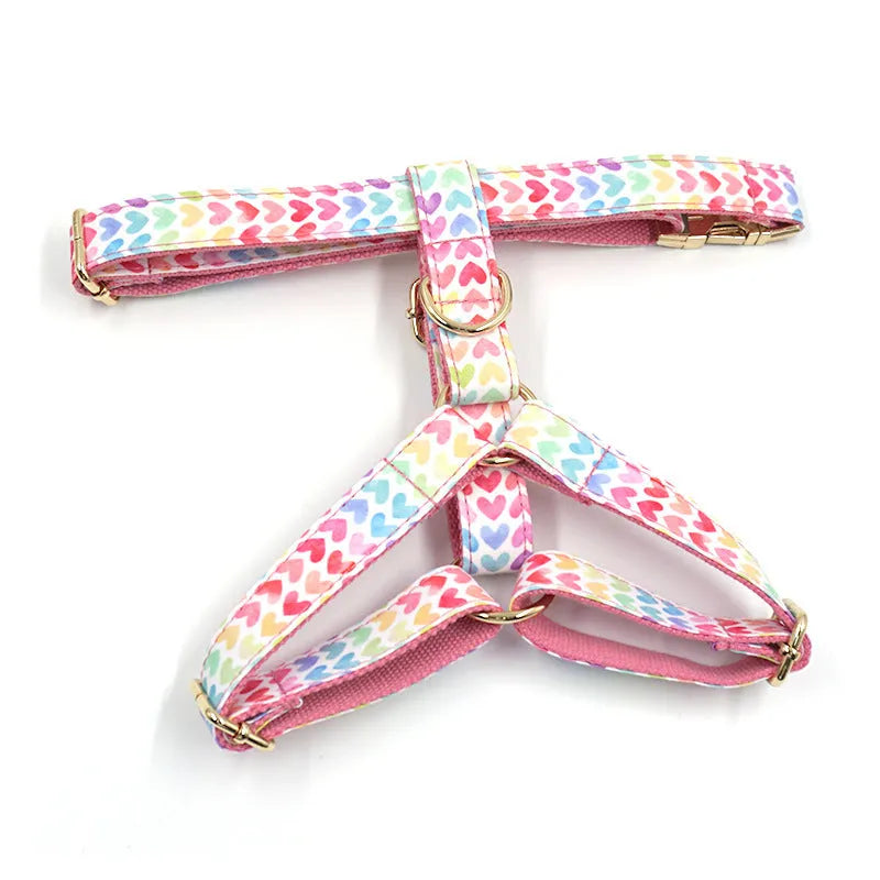 Pink dog harness with gold buckle and colourful heart-shaped stone decoration