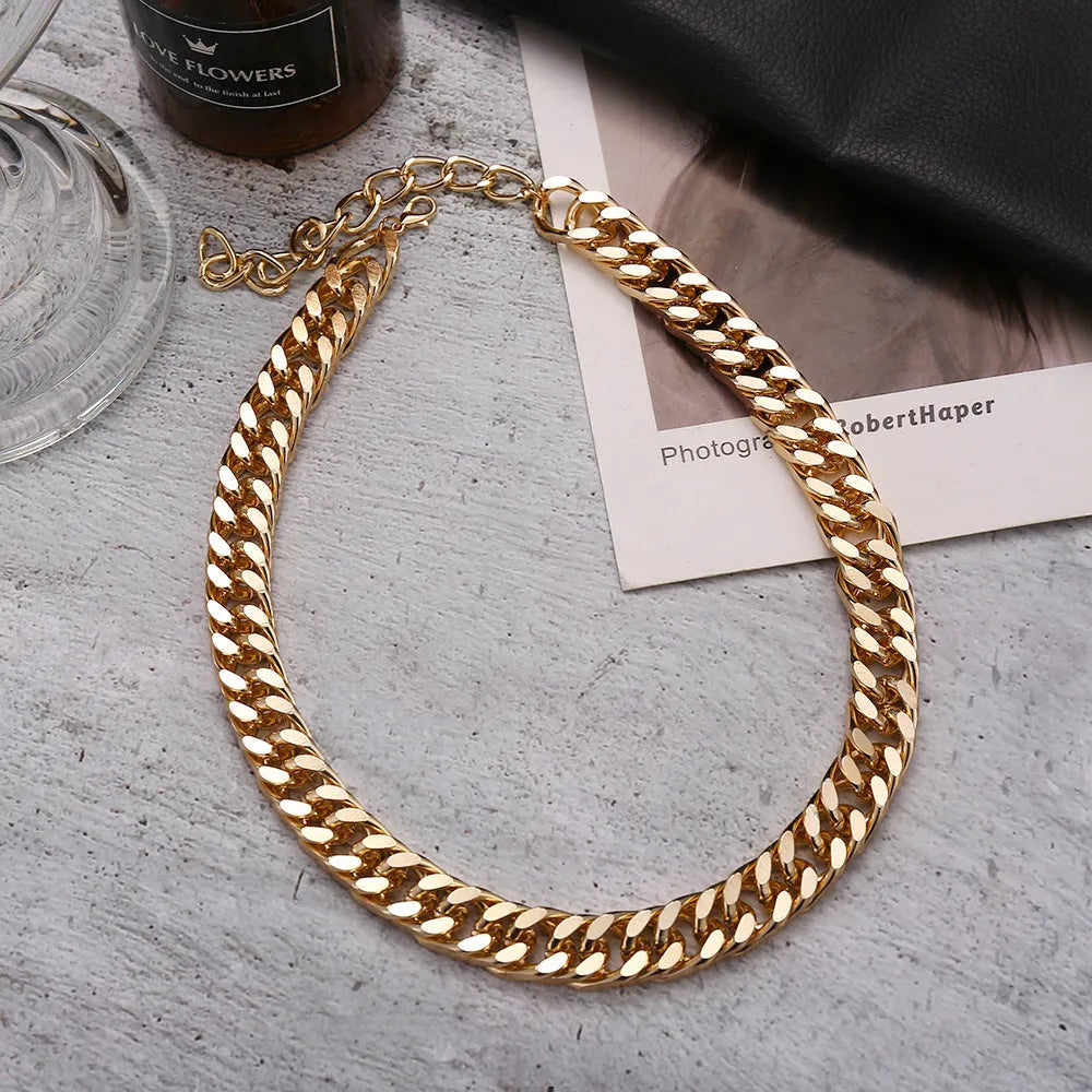 Gold tone thick chain women's necklace on a white background, showing the clasp and extender.