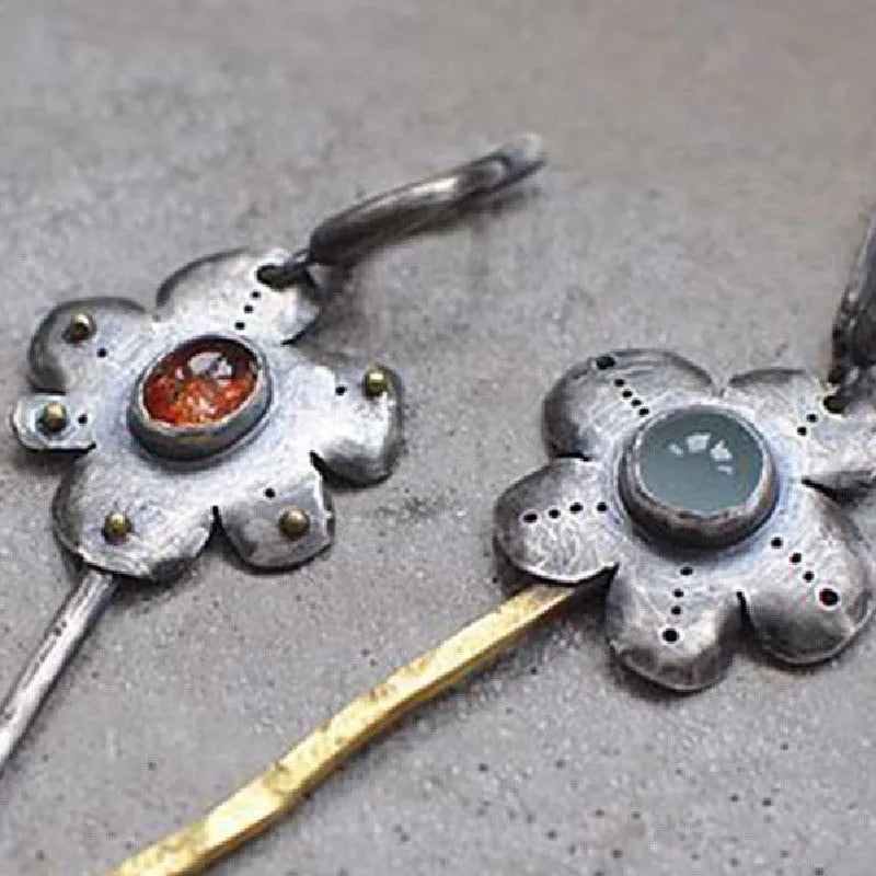 Long retro earrings with two-tone floral geometric design in alloy with electroplated finish.
