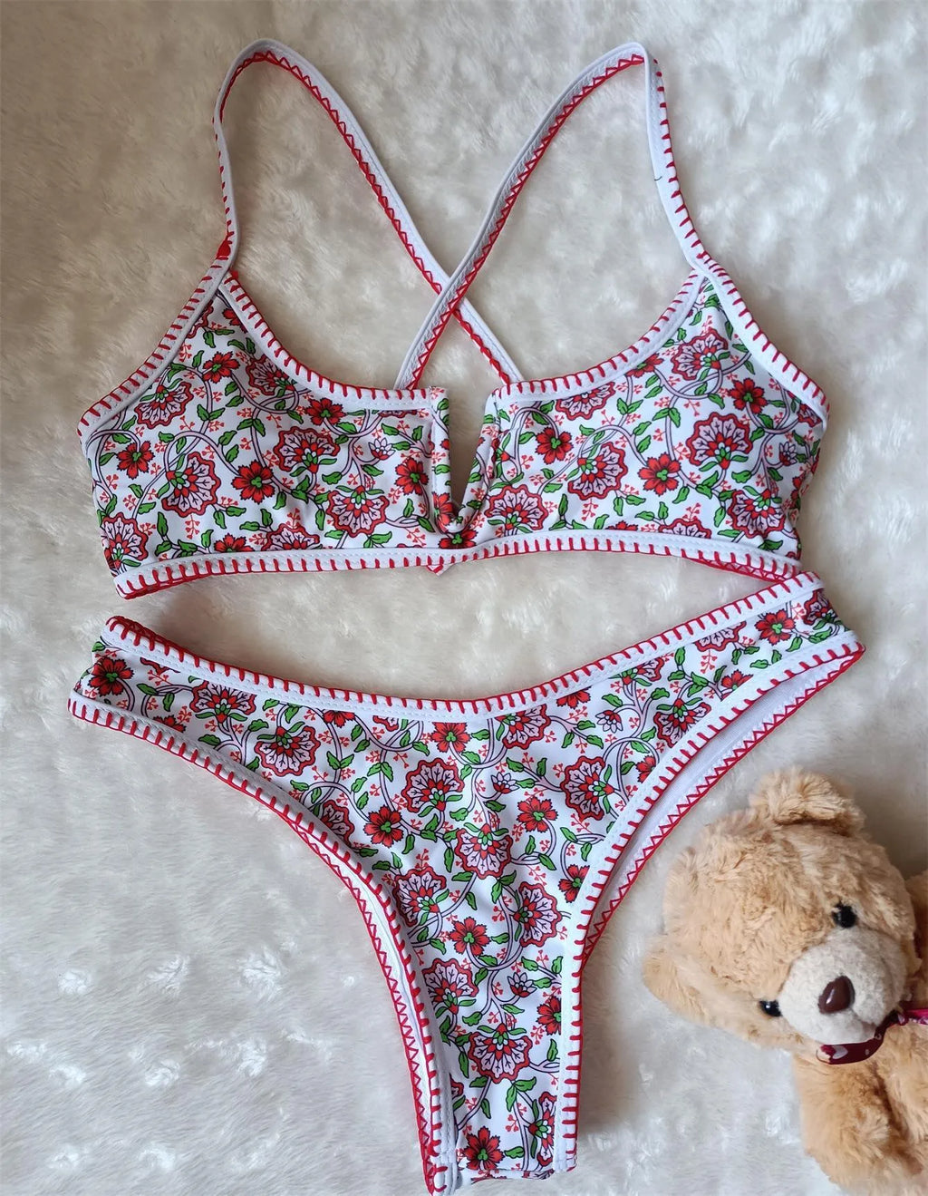 Women's V-neck swimsuit with floral embroidery in polyester fabric showing brief style cut