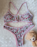 Women's V-neck swimsuit with floral embroidery in polyester fabric showing brief style cut