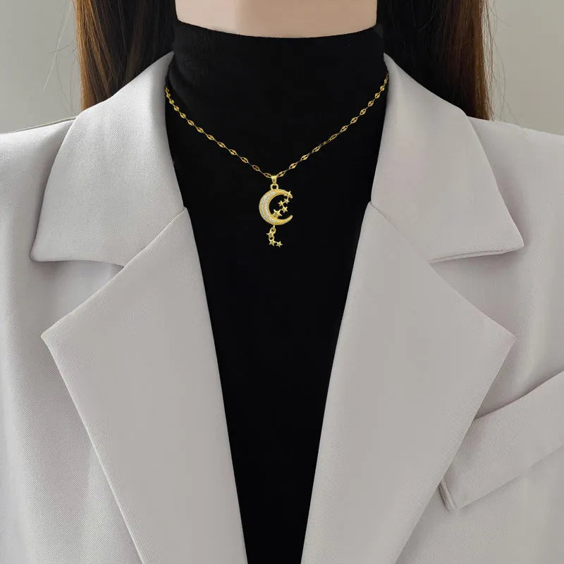 Stainless steel necklace with a geometric moon pendant and tassel chain detail.