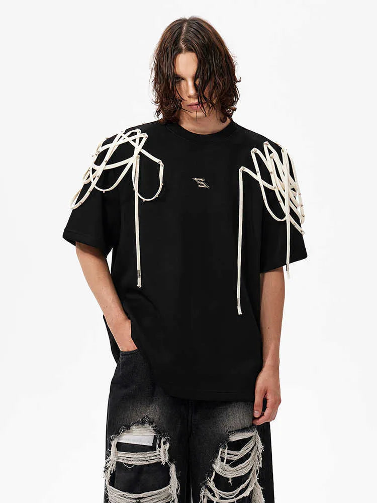 Black loose fit short-sleeve T-shirt with padded shoulders and decorative rivet ribbon detail on a hanger.