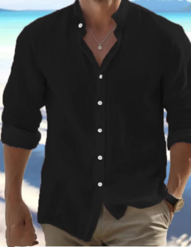 Man wearing a light blue long-staple cotton button-down beach shirt, casual summer style.