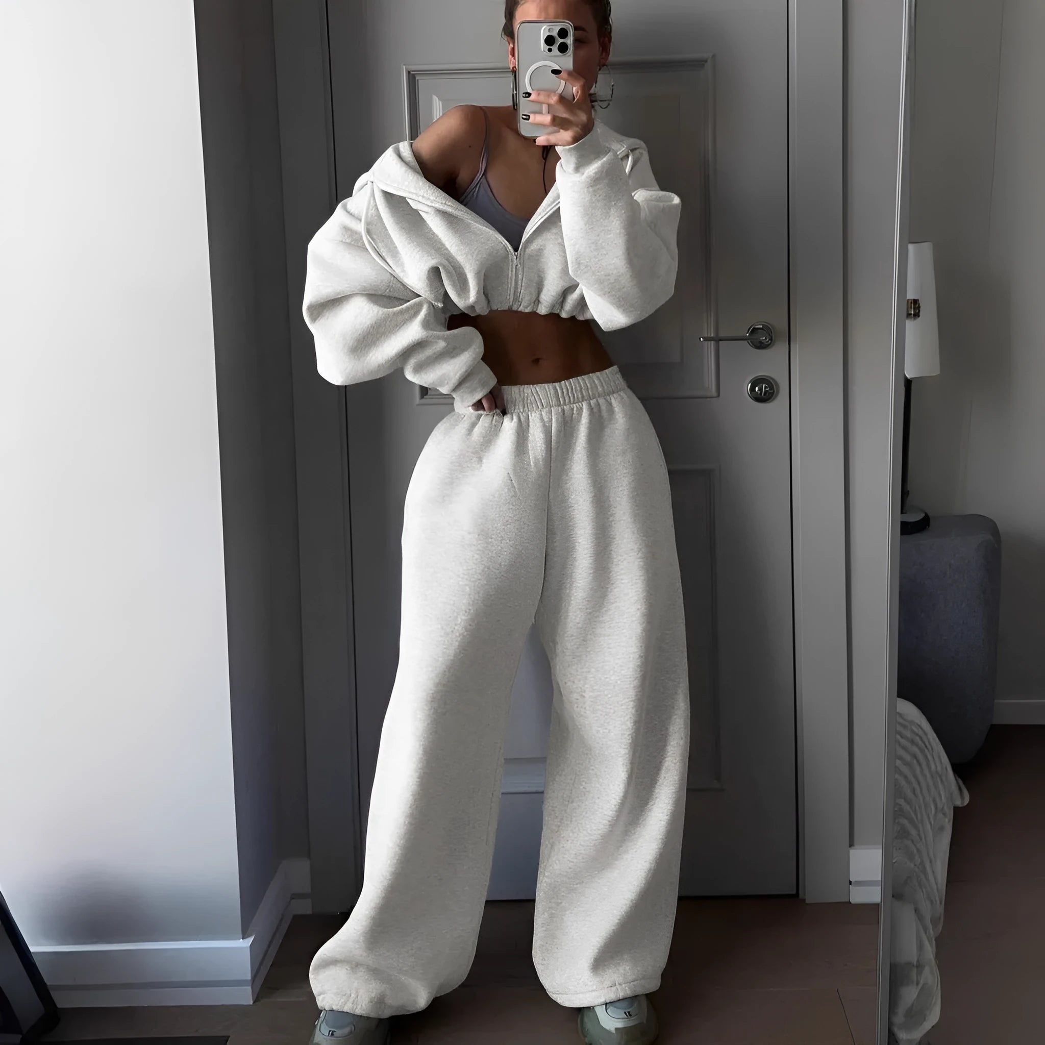 Long sleeve polyester sports sweater suit two-piece set in light grey, showing coat and trousers.