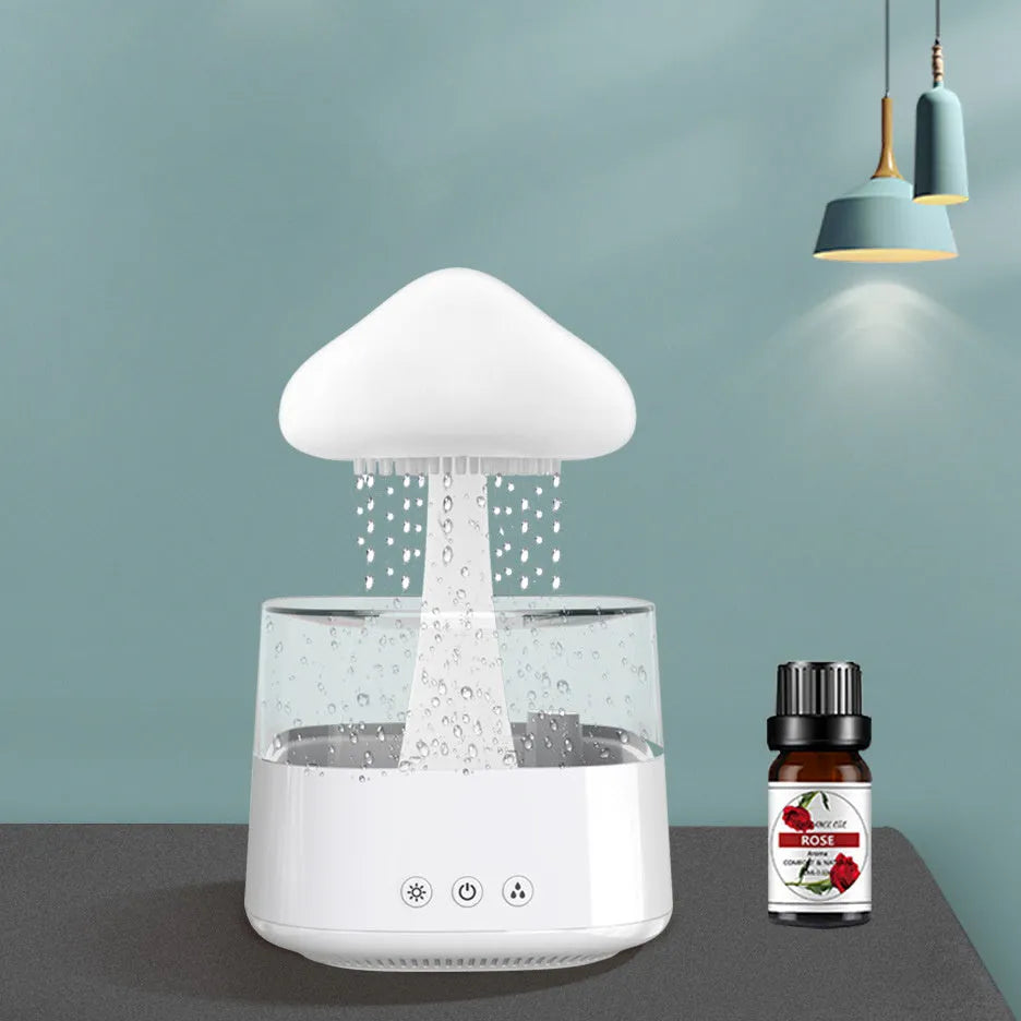 White raining cloud mushroom lamp humidifier and aromatherapy diffuser on a desk.
