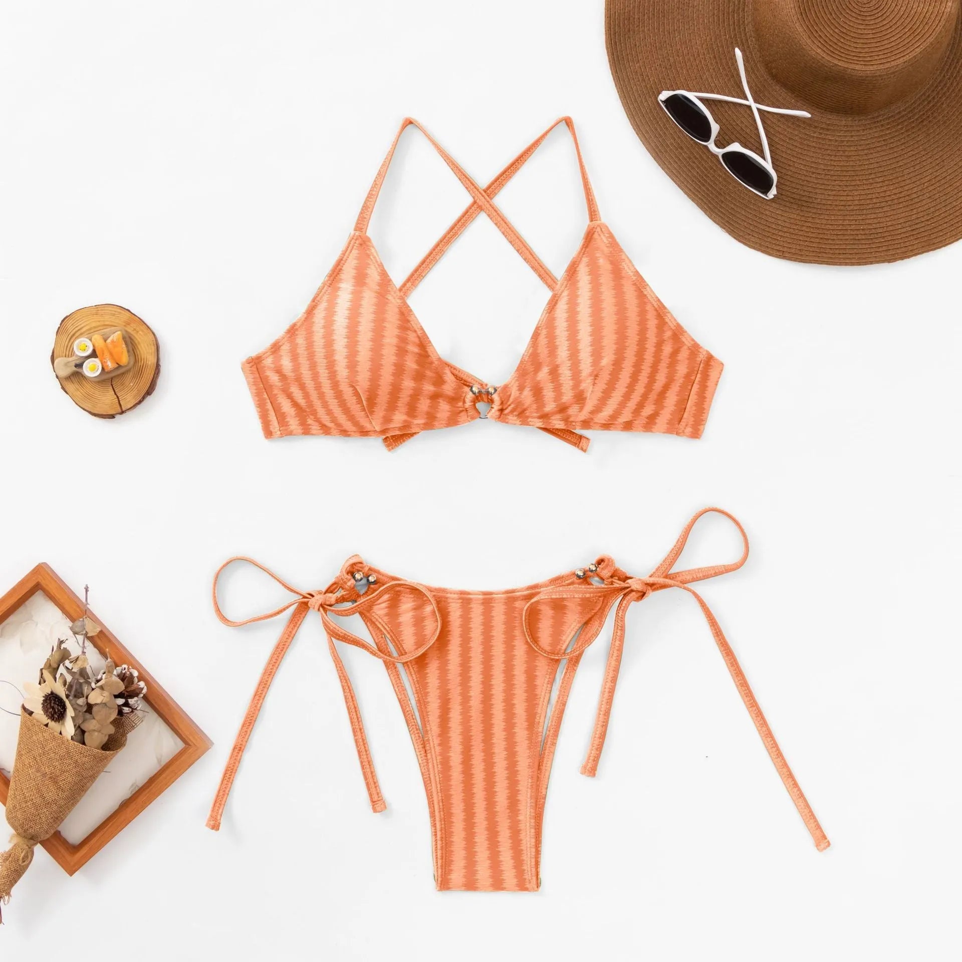 Red women's lace-up bikini top and briefs set on a mannequin, showing split design and backless style.