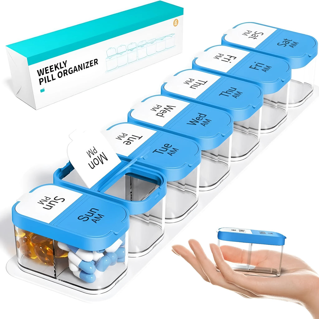 Extra large white and rainbow plastic pill organiser box with 14 removable grid compartments open on a table.