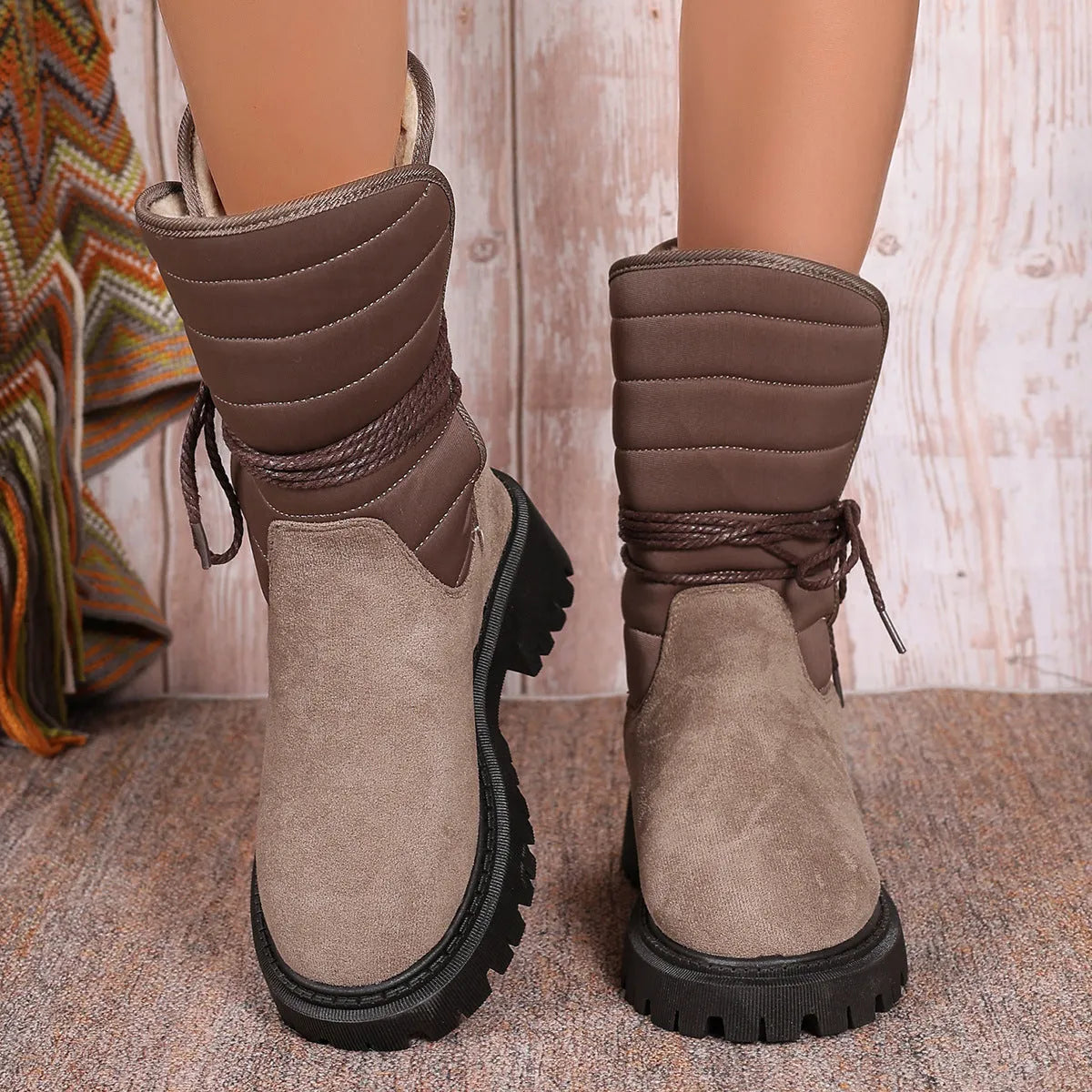 Women's chunky heel snow boots in suede with lace-up design and fleece lining, shown in black.
