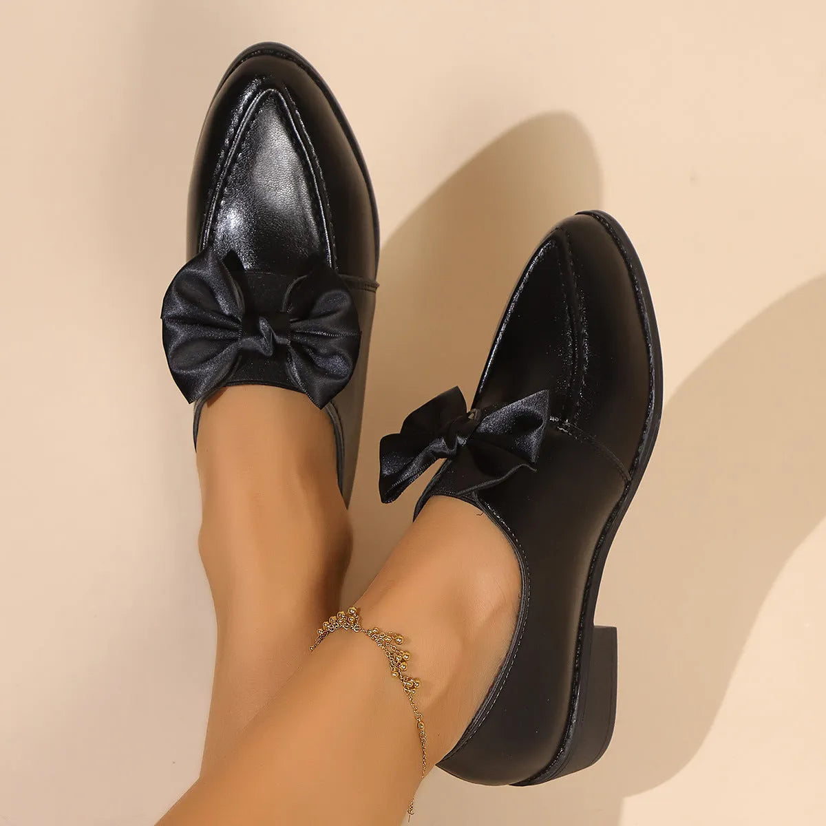 Women's British-style leather shoes with bow decoration, pointed toe, and slip-on design