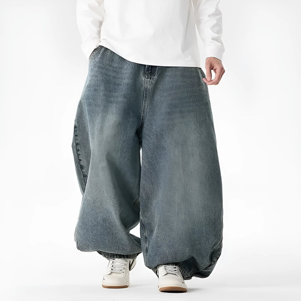 Men's plus size light blue baggy wide-leg jeans on a hanger, showing straight leg and low waist.