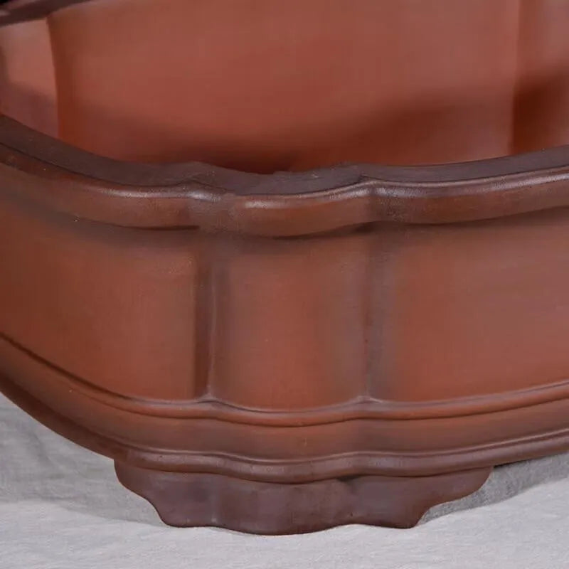 Large antique finish purple clay flower pot with Chinese tree stump design showing pine cypress pomegranate motifs
