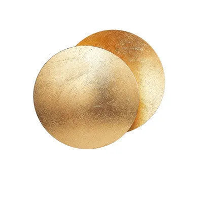 Round solar eclipse wall lamp with iron shade in black and brass finish.