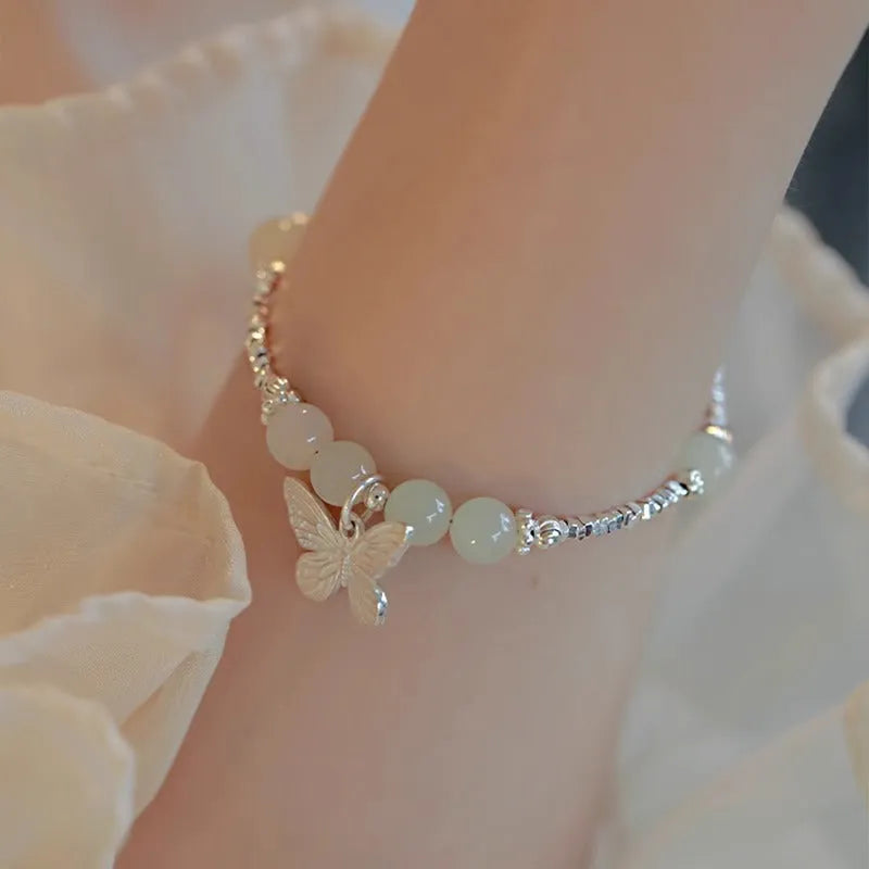 Silver butterfly jewellery set with hetian jade accents showing bracelet and necklace combination