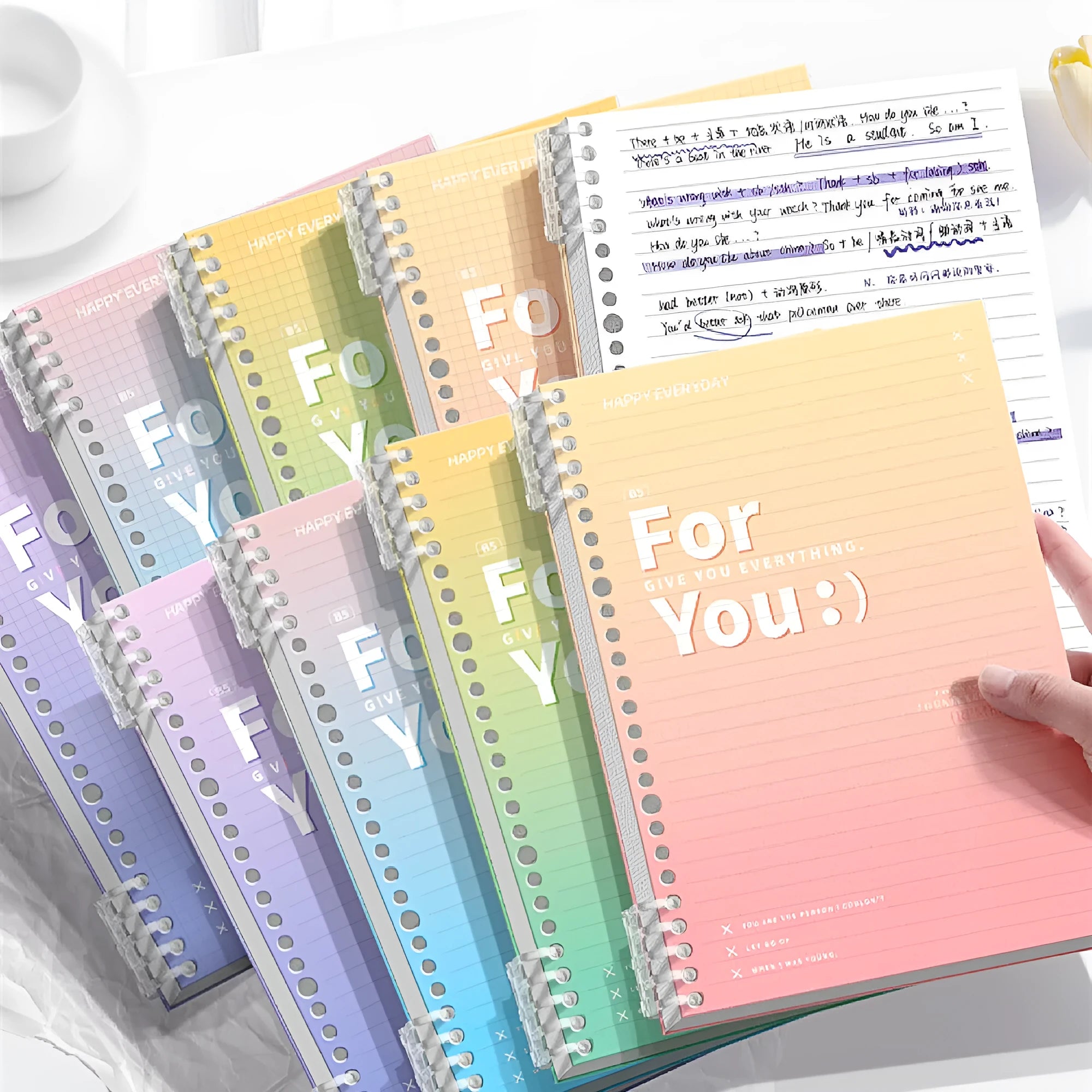Removable coil notebook with gradient coloured cover in blue, showing coil binding and wood-free paper pages