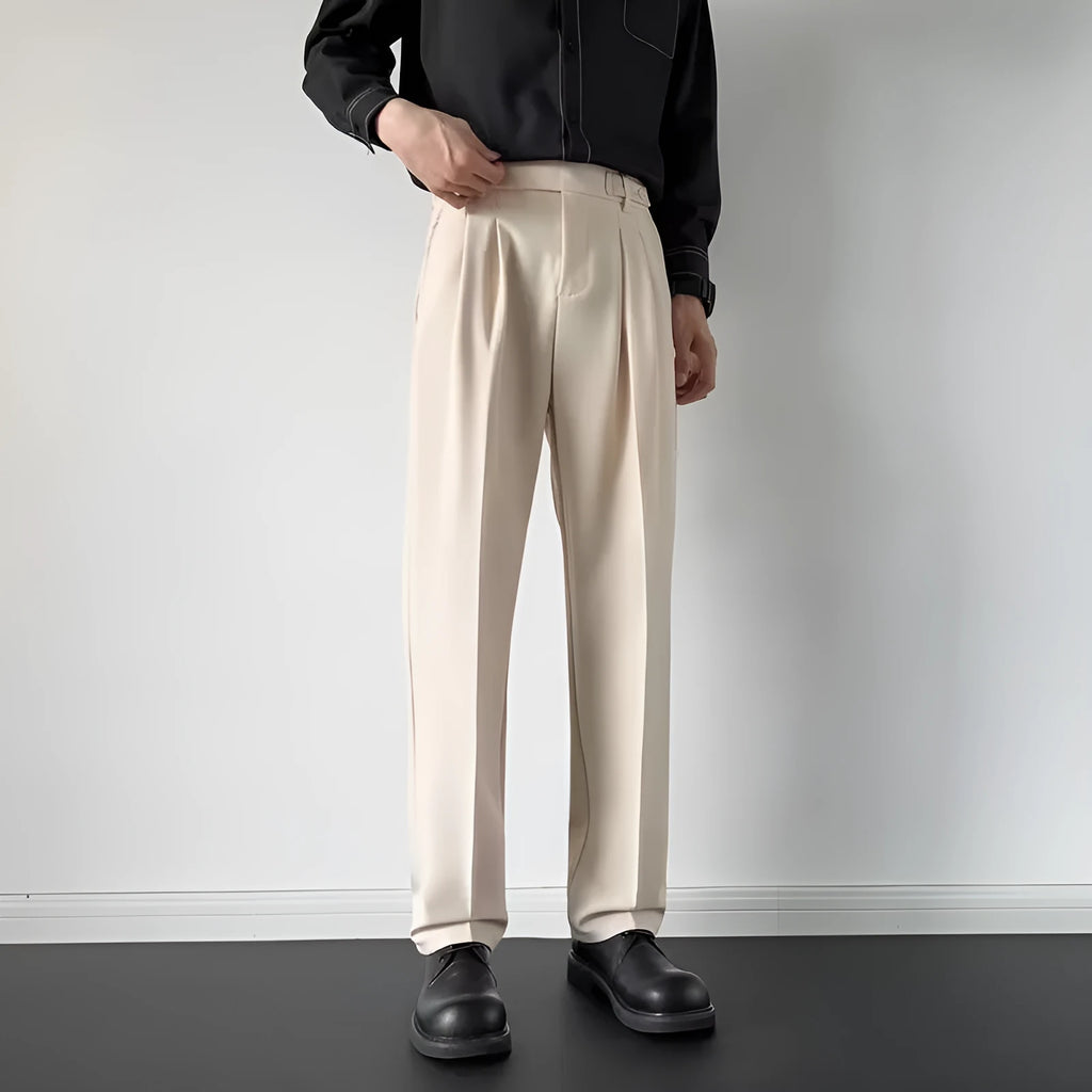 Men's apricot and black straight-leg loose fit suit trousers made from polyester fabric.