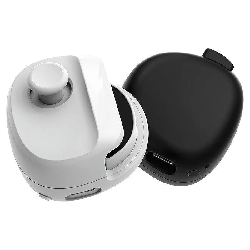 Black USB gaming stick controller on a desk next to a mobile phone