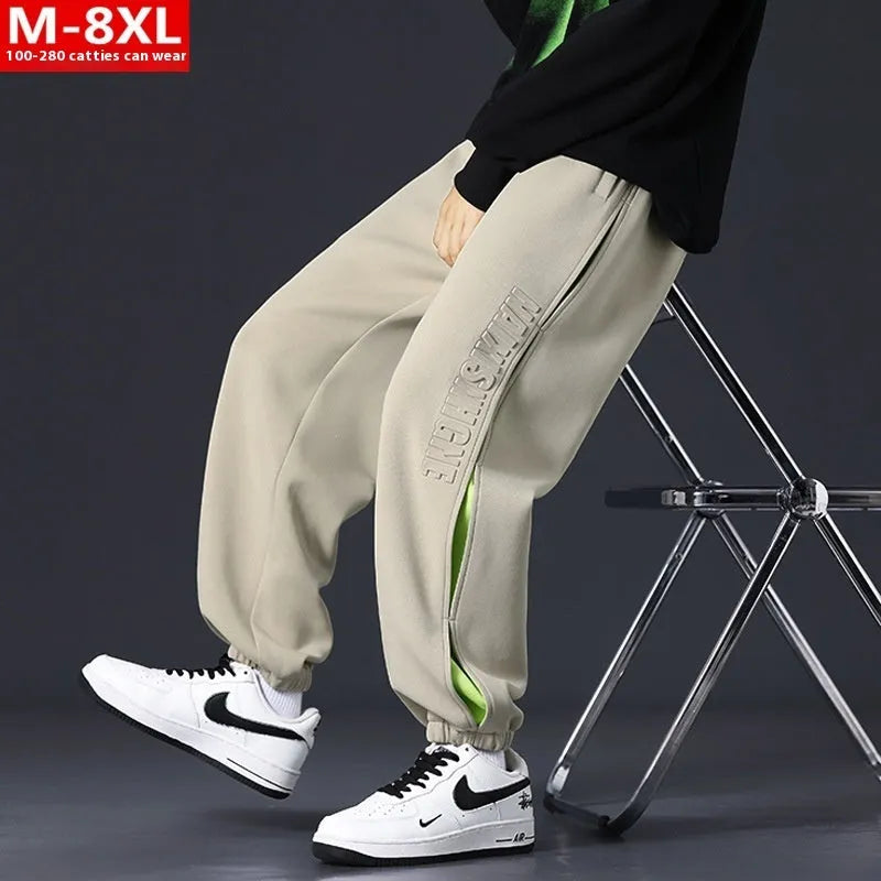 Men's loose cotton trousers with elasticated ankle bands and collage stitching details in khaki colour